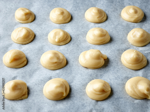 Canvas-taulu raw cream puffs on baking pan