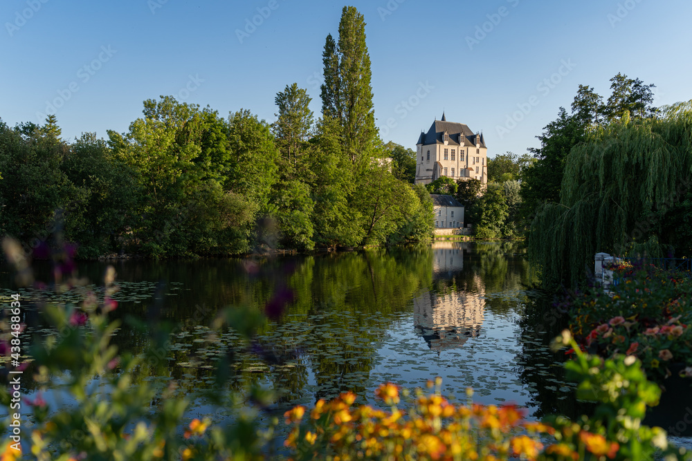 Castle Raoul with Yellow Flower and Reflection in Water in Chateauroux city, France Castle Raoul with Yellow Flower and Reflection in Water in Chateauroux city, France