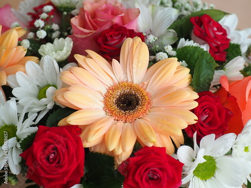 A beautiful bouquet of gerberas  chrysanthemums and roses. Postcard for the holiday. Mixed flower arrangement