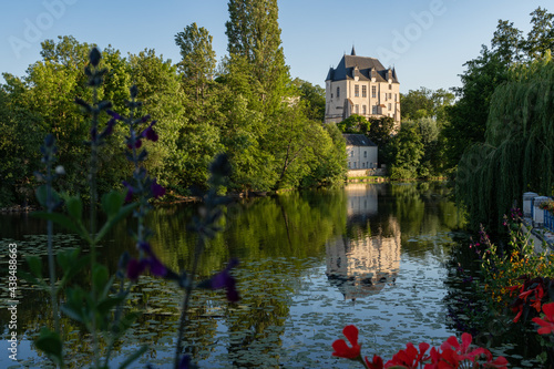 Castle Raoul with Red Flower and Reflection in Water in Chateauroux city, France photo