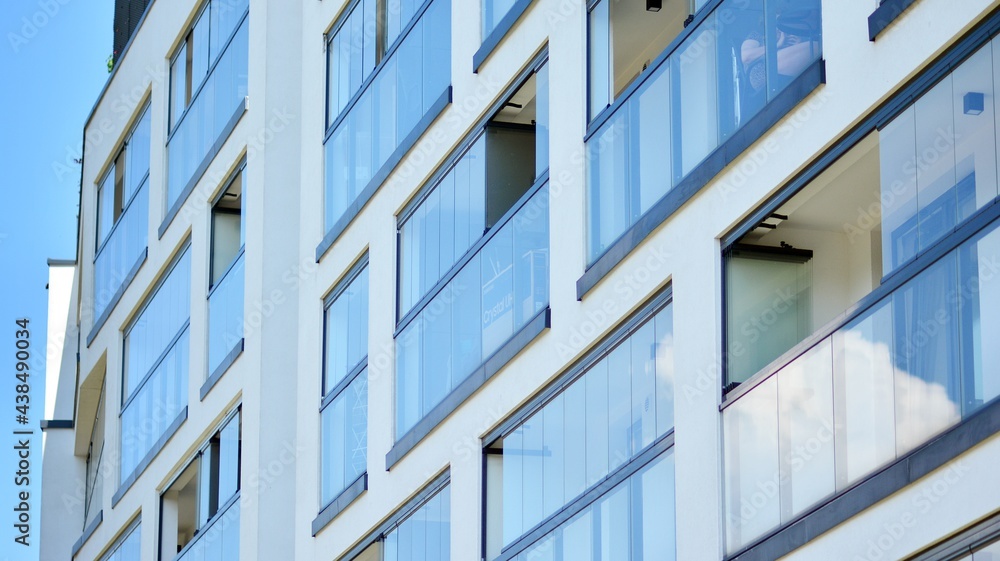Fragment of modern luxury residential apartment, home house building concept. Modern apartment building on a sunny day with a blue sky. Fragment of modern luxury residential apartment, home house building concept. Modern apartment building on a sunny day with a blue sky.