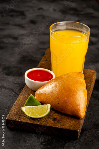 Arabic meat sfiha with juice cop on the table.