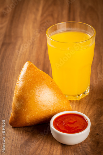 Arabic meat sfiha with juice cop on the table.
