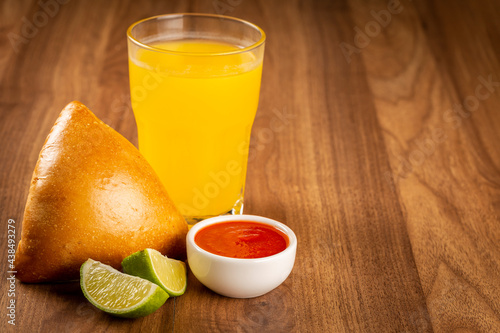 Arabic meat sfiha with juice cop on the table.