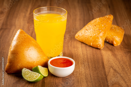 Arabic meat sfiha with juice cop on the table.