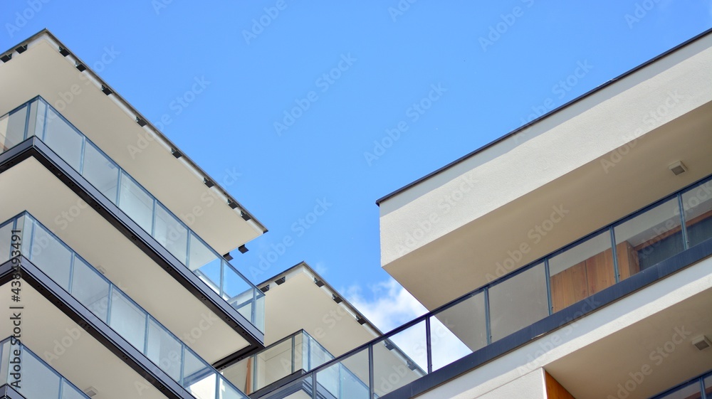 Fragment of modern luxury residential apartment, home house building concept. Modern apartment building on a sunny day with a blue sky. Fragment of modern luxury residential apartment, home house building concept. Modern apartment building on a sunny day with a blue sky.