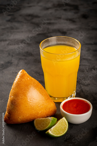 Arabic meat sfiha with juice cop on the table.