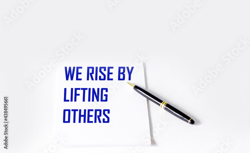 Quote with inscription on a white notebook about the life and work we raise by helping others