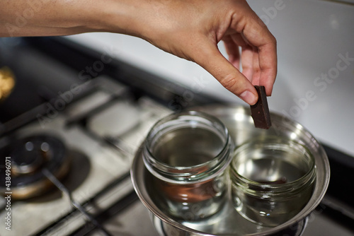 Close-up of a woman s hands making chocolate in a bain-marie