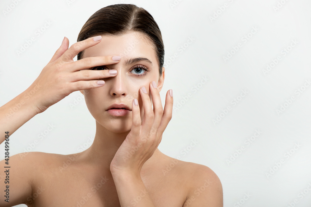 Beautiful young woman with clean perfect skin. Portrait of beauty model with natural nude make up and and hand with manicure touching face. Spa, skincare and wellness. Close up, background, Beautiful young woman with clean perfect skin. Portrait of beauty model with natural nude make up and and hand with manicure touching face. Spa, skincare and wellness. Close up, background,