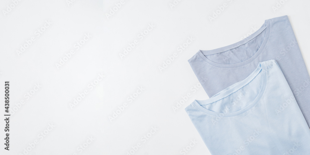 Flat lay blank folded blue t-shirts on a white background