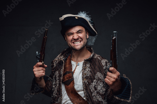 Bilde på lerret Angry corsair with pistols against dark background