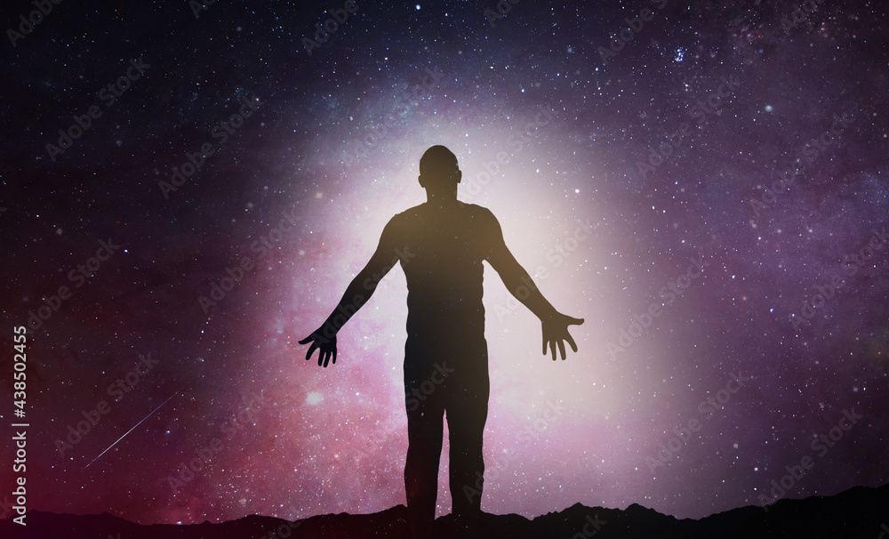 Silhouette of man stand and see in the night sky with stars. Galaxy and space. Light from the chest. Astrology sign. Esoterica and psychology Silhouette of man stand and see in the night sky with stars. Galaxy and space. Light from the chest. Astrology sign. Esoterica and psychology