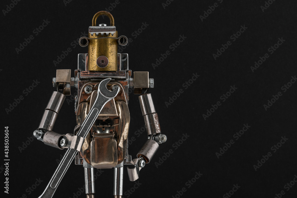 Fototapeta premium Steampunk robot holding wrench. Chrome and bronze parts.