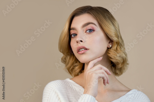 Portrait of beautiful young woman with perfect young skin and professional makeup, close up. Winter seasonal beauty concept.