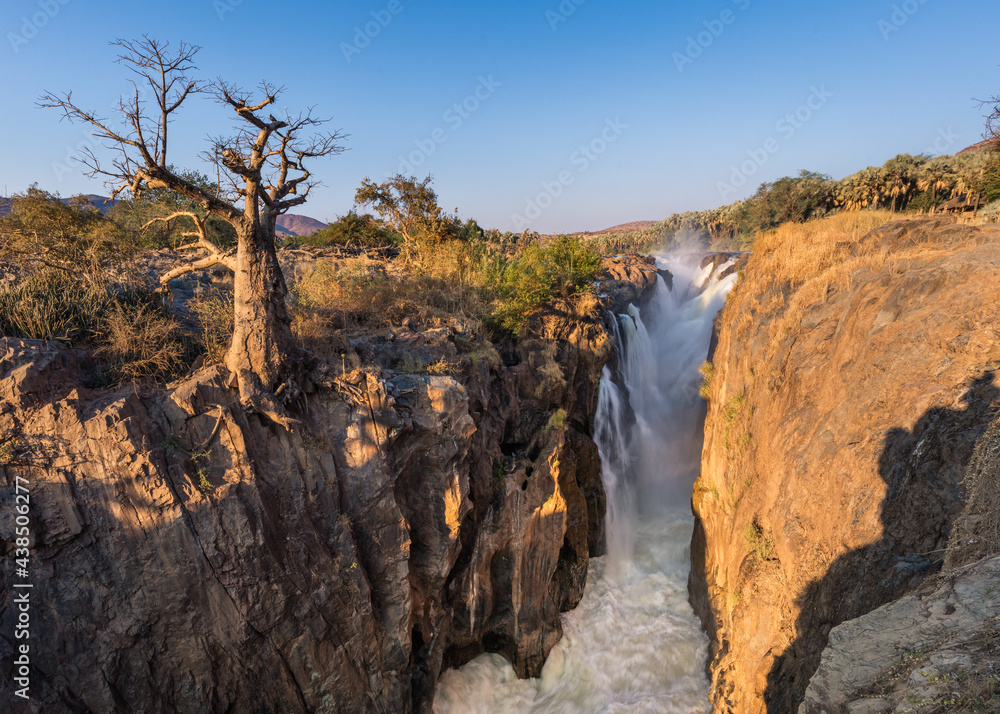 A lone baobab hangs on edge of the rocky Kunene  river canyon at the Epupa falls,  Kaokoveld, Namibia/Angola border. 