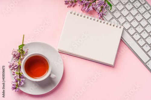 Trendy workspace design with colors, keyboard on pink background top view. Space for text in a notepad for writing