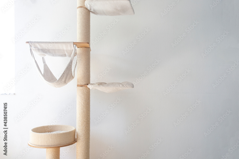 Cat scratching post wall mounted in modern room for pet on white wall, stylish decoration for cat owner Cat scratching post wall mounted in modern room for pet on white wall, stylish decoration for cat owner