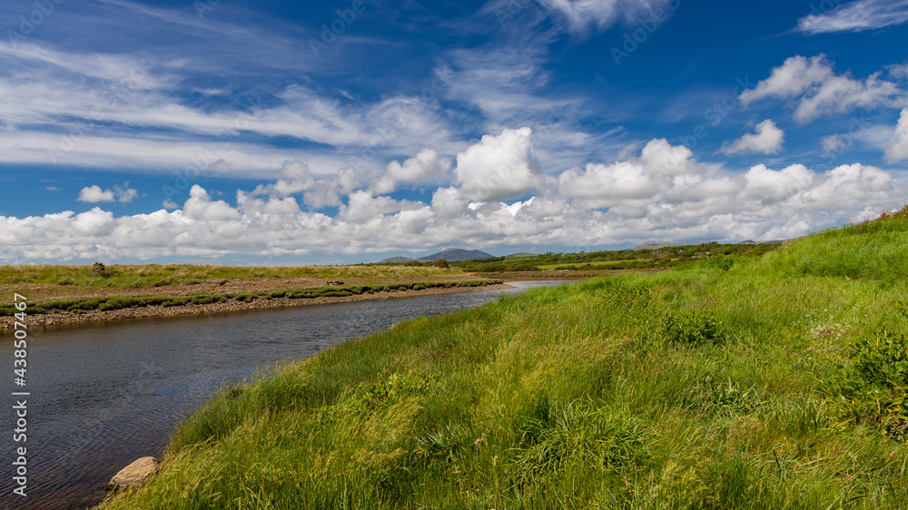Fototapeta premium The River Dwyfor flowing through the fields on a summers Day