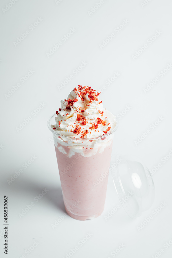 Glasses of fresh strawberry milkshake, Summer drink shake with slice of strawberry on bright background Glasses of fresh strawberry milkshake, Summer drink shake with slice of strawberry on bright background