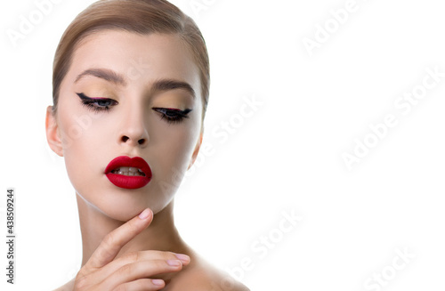 Portrait of beauty model with bright color red lip makeup and arrows on eyes. Beautiful young woman with professional make up and long eyelashes