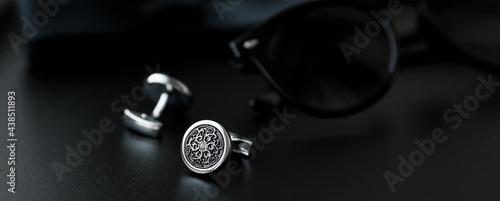 luxury men's cufflinks with sunglasses on black background.
