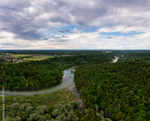 Fototapeta Naklejka Na Ścianę i Meble -  Bending river surrounded by vivid green tees, wunderful nature, a concept for fresh and pure environment at an idyllic place captured by a drone.
