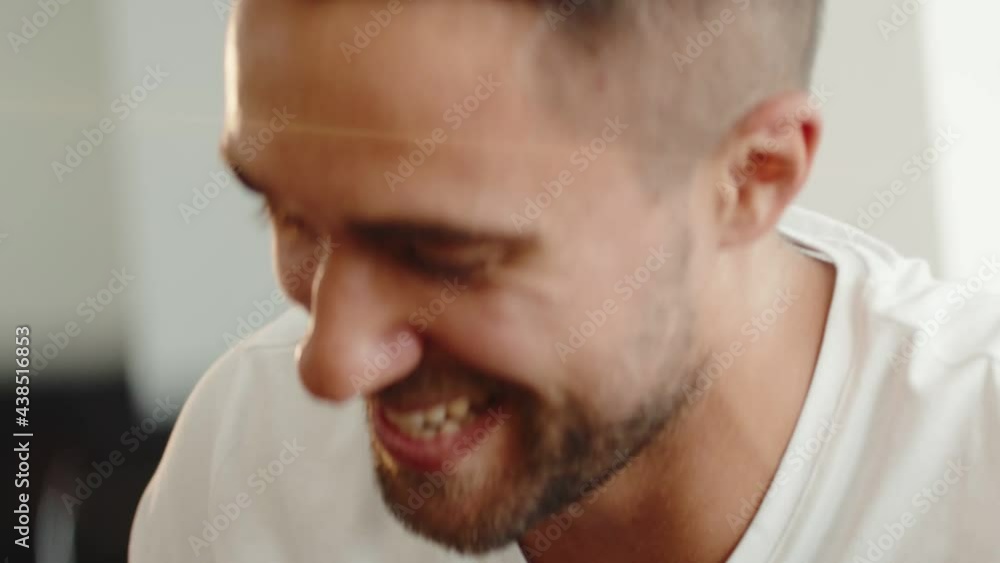 Smiling bearded millennial professional businessman talking with his colleague.
