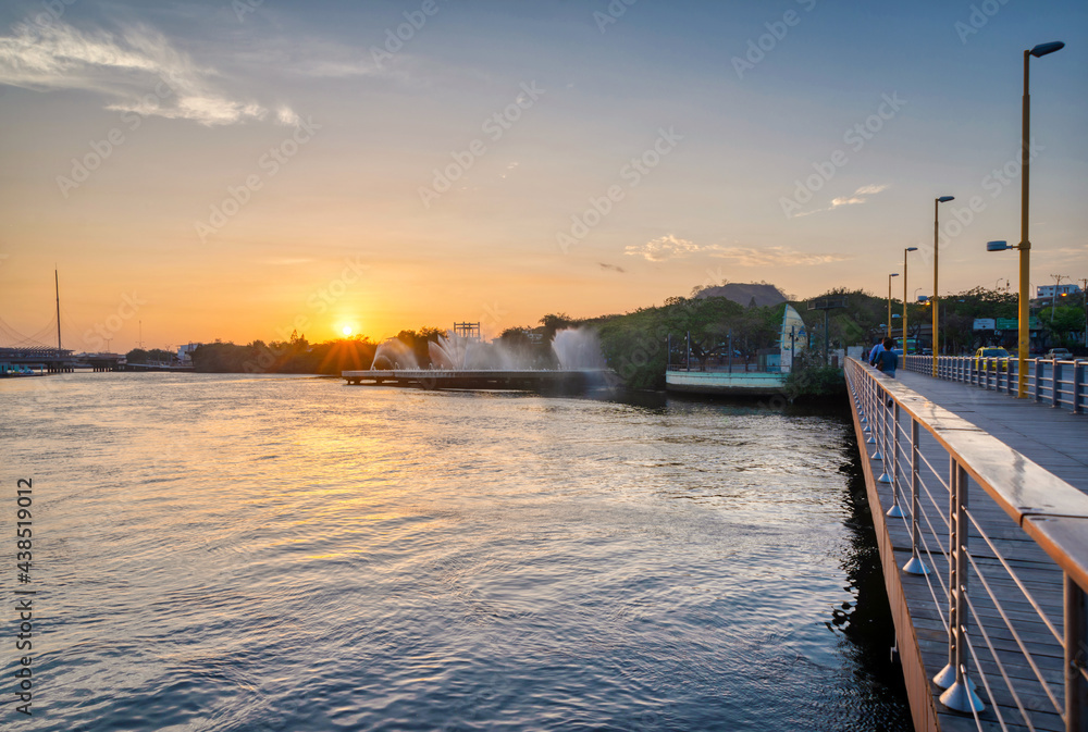 View of the Estero del Salado (Estuary of the Salty), from the Puente del Velero (Sailboat Bridge), in Guayaquil, Ecuador, at sunset and with a big fountain as decoration. 