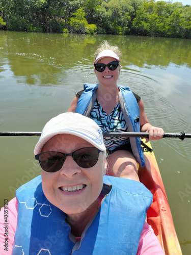 Mother and daughter in kayak on open water