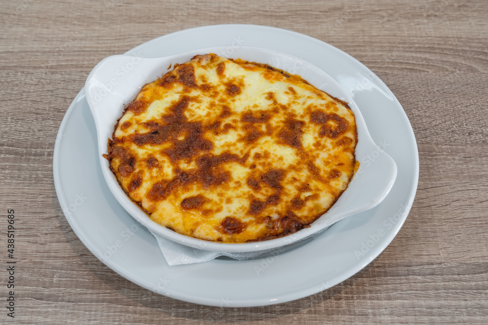Lasagne alla Bolognese, Baked with Meat Ragu on a White Plate Served, in a plate, top view. Lasagne alla Bolognese, Baked with Meat Ragu on a White Plate Served, in a plate, top view.