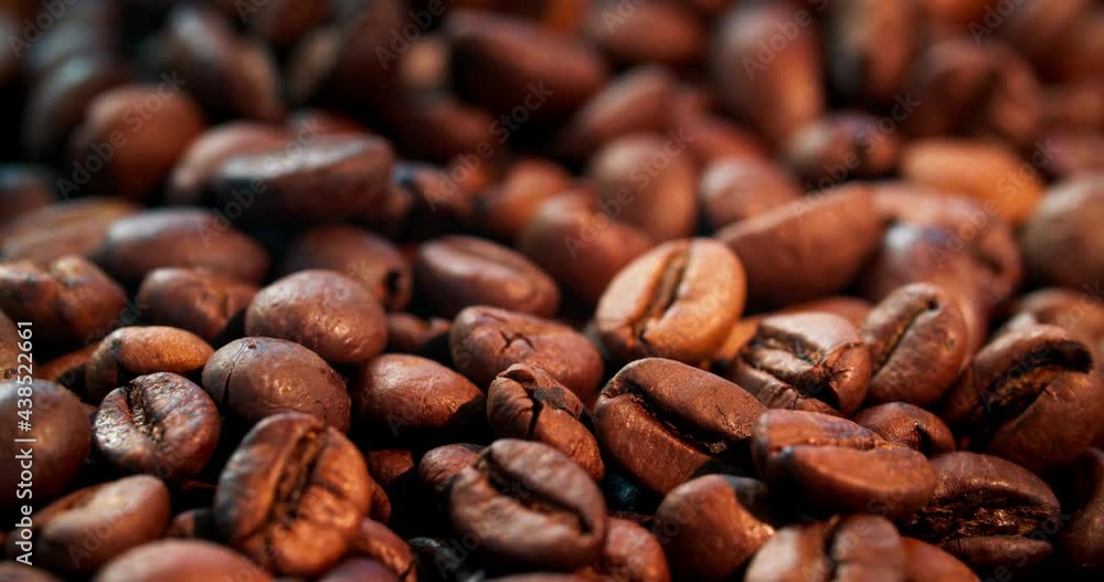 Large quantities of roasted arabica beans. Camera movement, macro photography. beautiful bright color of delicious coffee Large quantities of roasted arabica beans. Camera movement, macro photography. beautiful bright color of delicious coffee