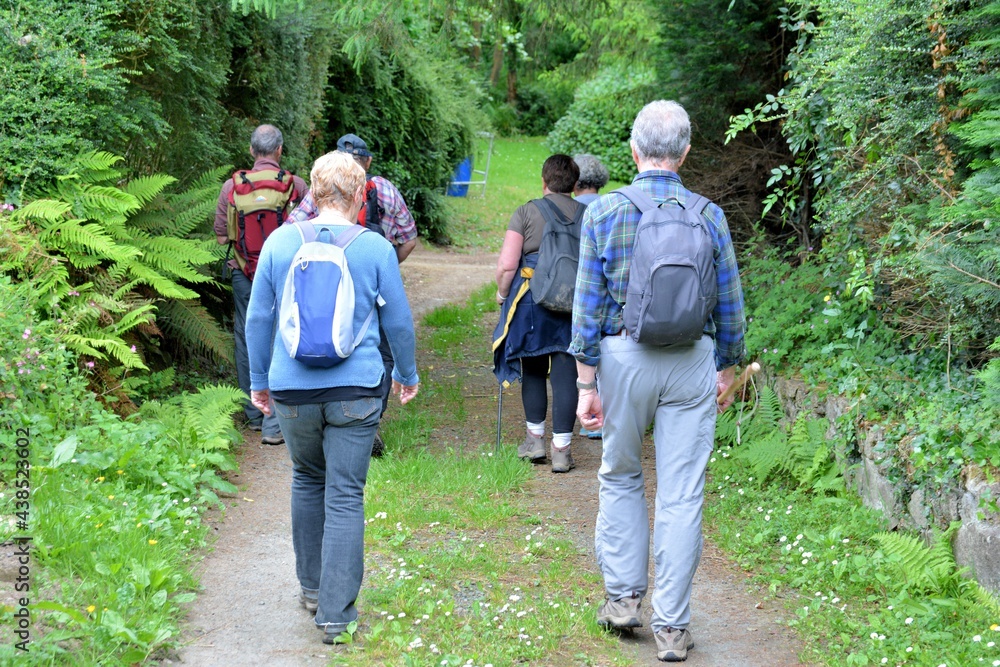 Senior hikers on a path in Brittany France Senior hikers on a path in Brittany France