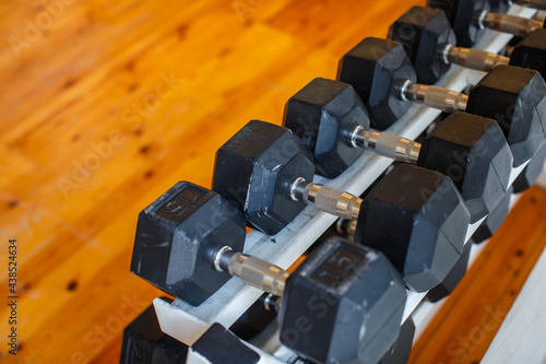 Fitness equipment. Dumbbell or barbell on wooden background