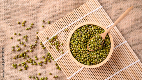 Mung bean seeds in a wooden spoon and bowl, Food ingredients in Asian cuisine and produce mung bean sprout photo