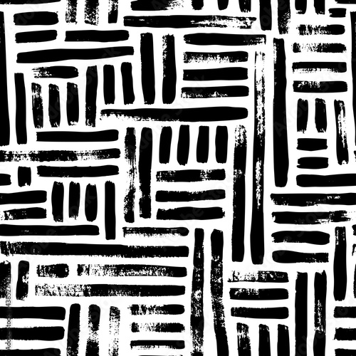 Abstract geometric pattern with black interrupted dotted lines on white background. Vertical and horizontal parallel lines. Vector seamless pattern with black brush strokes. Hand drawn ornament.