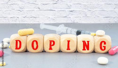 word DOPING on wooden block, medical concept