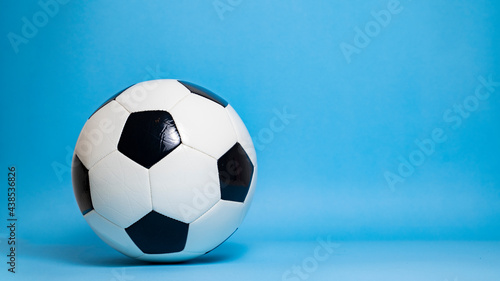 Real soccer ball on blue background 