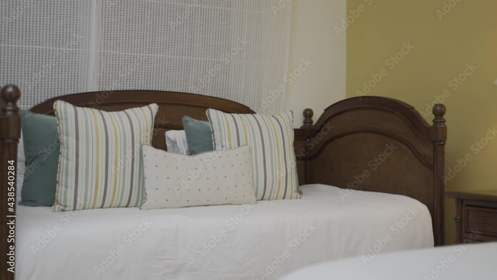 children's bed and adult bed next to lighted lamp children's bed and adult bed next to lighted lamp