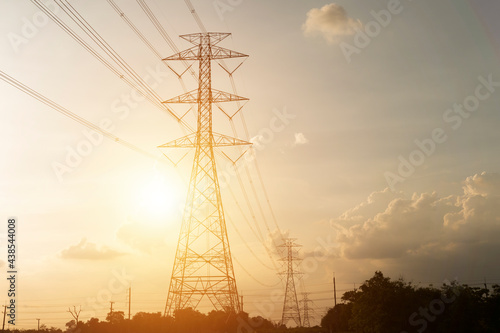 silhouette, high voltage tower and bright sky