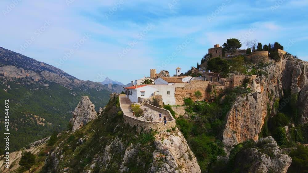 A loving couple contemplates the mountainous landscape of Guadalest A loving couple contemplates the mountainous landscape of Guadalest