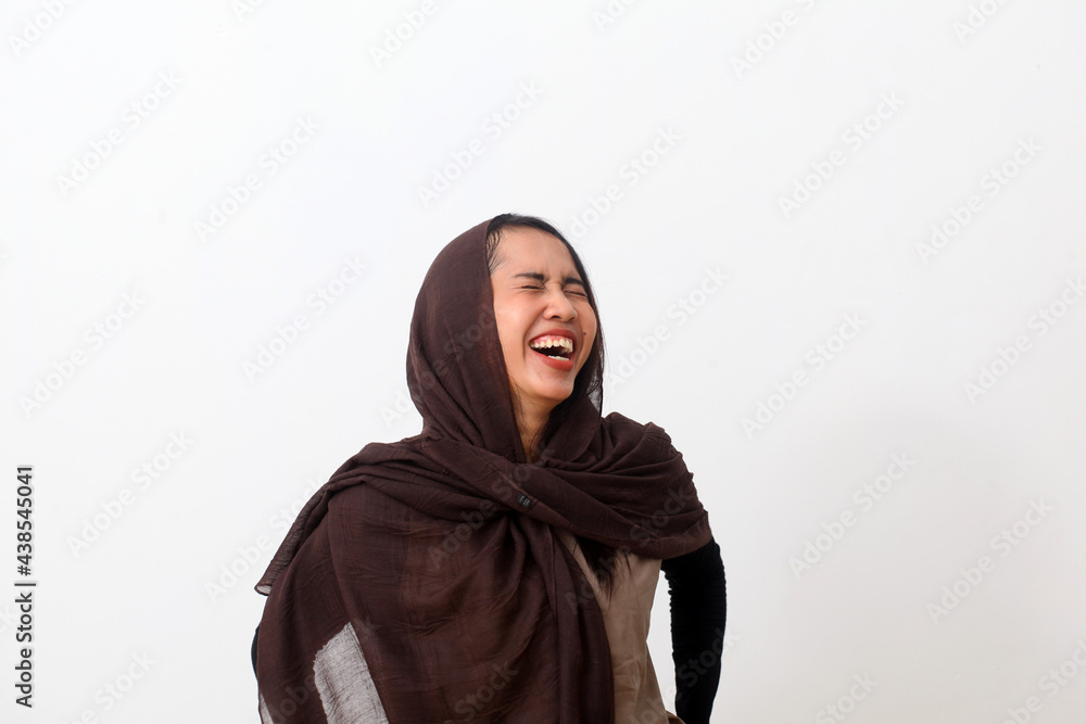 A portrait of happy asian muslim woman wearing a veil or hijab laughing. Isolated on white background with copy space A portrait of happy asian muslim woman wearing a veil or hijab laughing. Isolated on white background with copy space