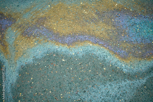 Oil stain on Asphalt, color Gasoline fuel spots on Asphalt Road as Texture or Background. Iridescent stains of gasoline.