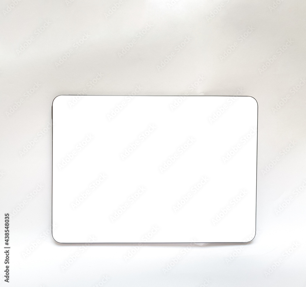 The tablet is black on a white isolated background with a mock up. Back side view of the tablet