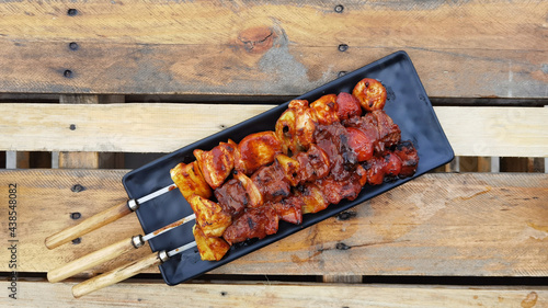 Barbecue with delicious grilled meat on the plate