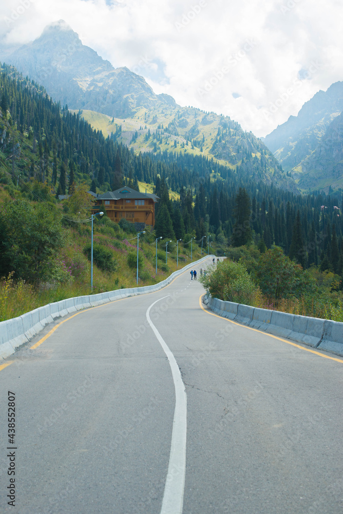 long road and high mountains in summer. High quality photo