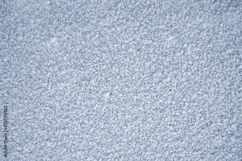 Ice frost natural background, covered with white hoarfrost crystals. Snow backdrop.