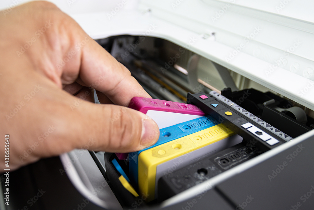 Technicians are install setup the ink cartridge of a inkjet printer the device of office automate for printing
