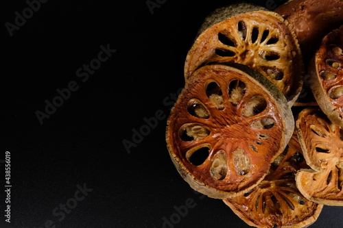 Dry Bael Fruit isolate on black background.

Dry Bael Fruit for making herbal juice.

Properties that add freshness has a delicate fragrance.