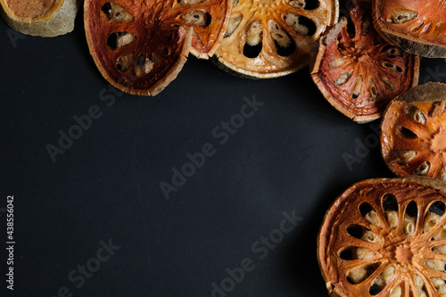 Dry Bael Fruit isolate on black background.

Dry Bael Fruit for making herbal juice.

Properties that add freshness has a delicate fragrance.